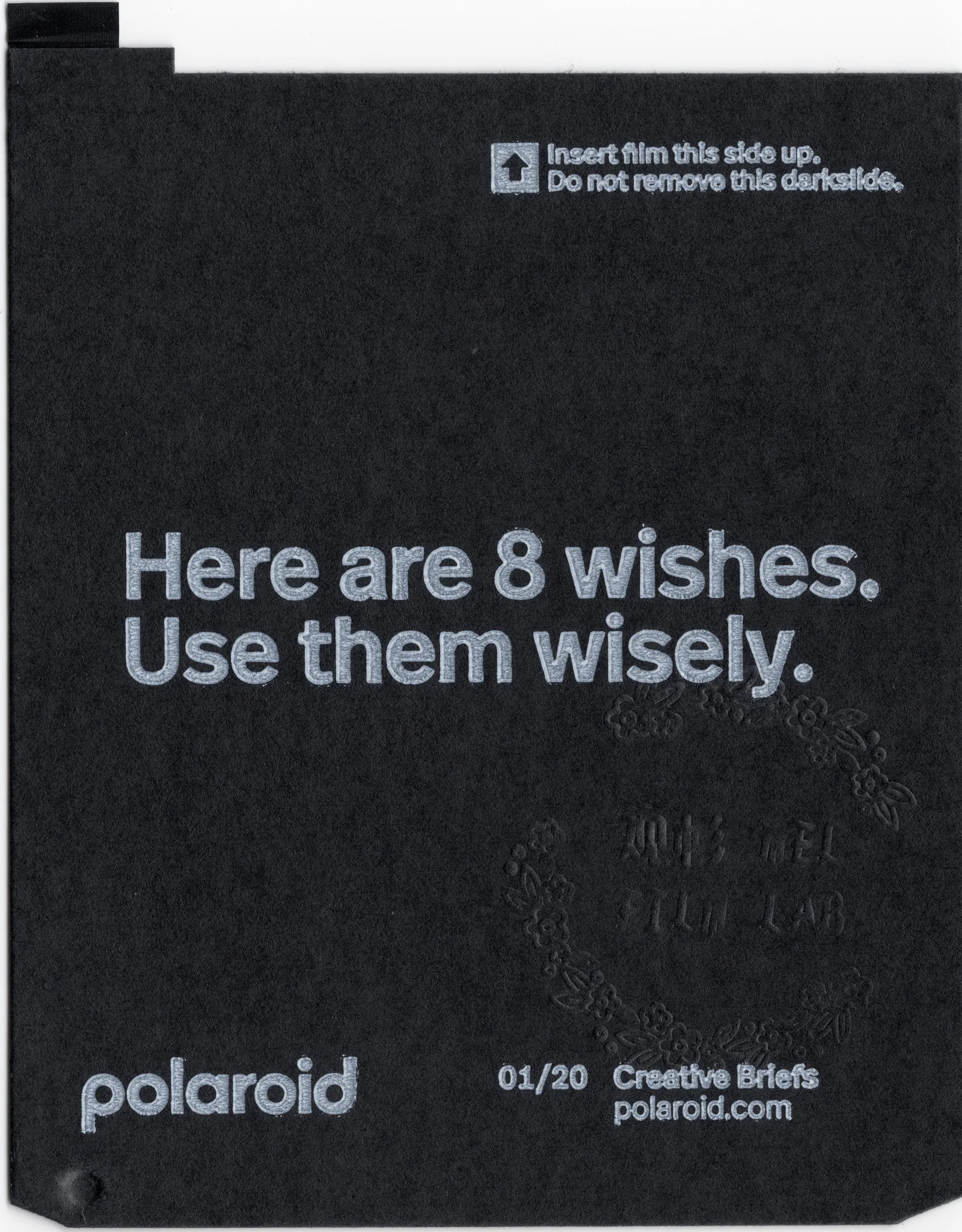 Black Polaroid darkslide with the phrase Here are 8 wishes. Use them wisely.