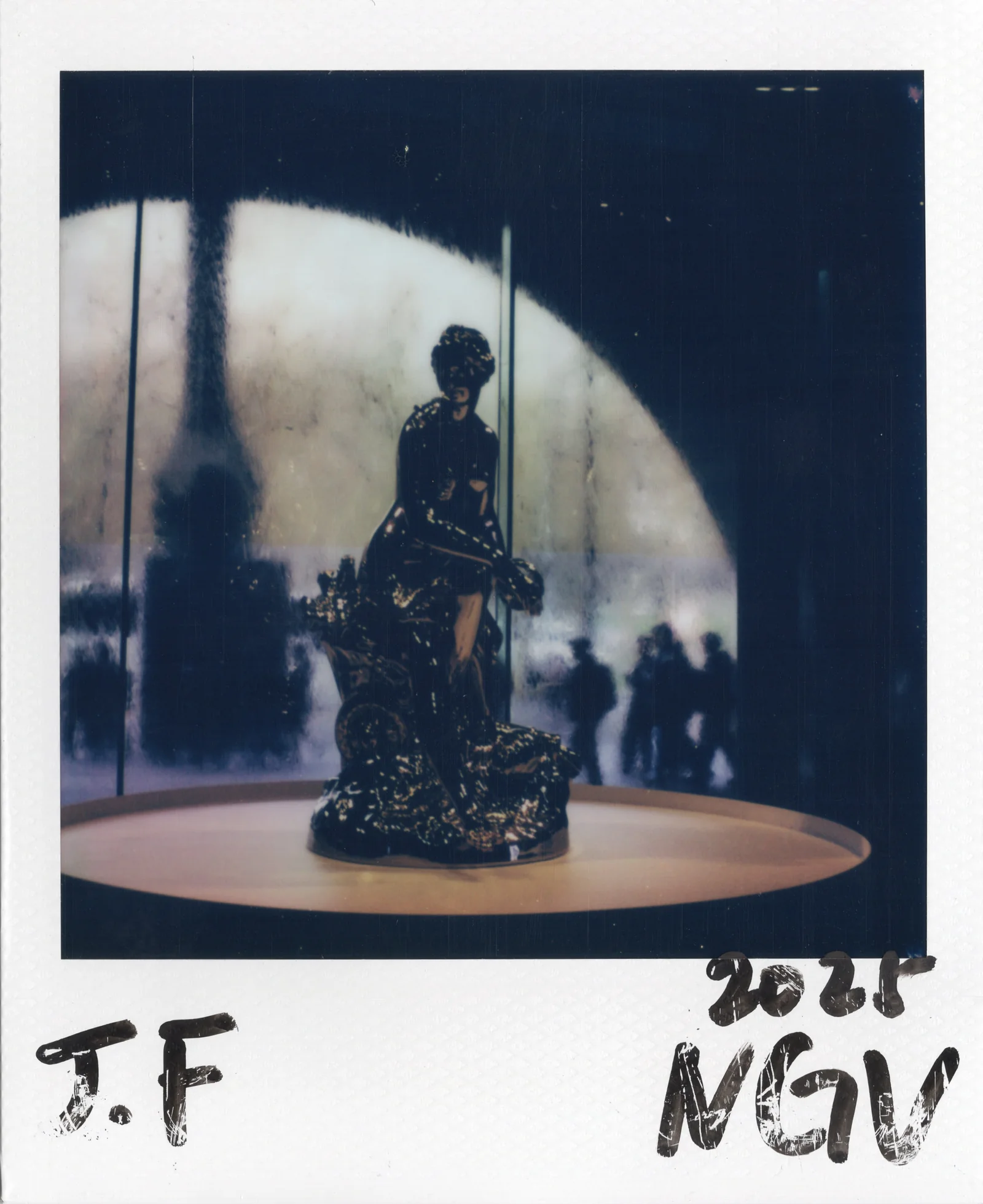 Polaroid artwork of a sculpture staged in a museum-like environment.
