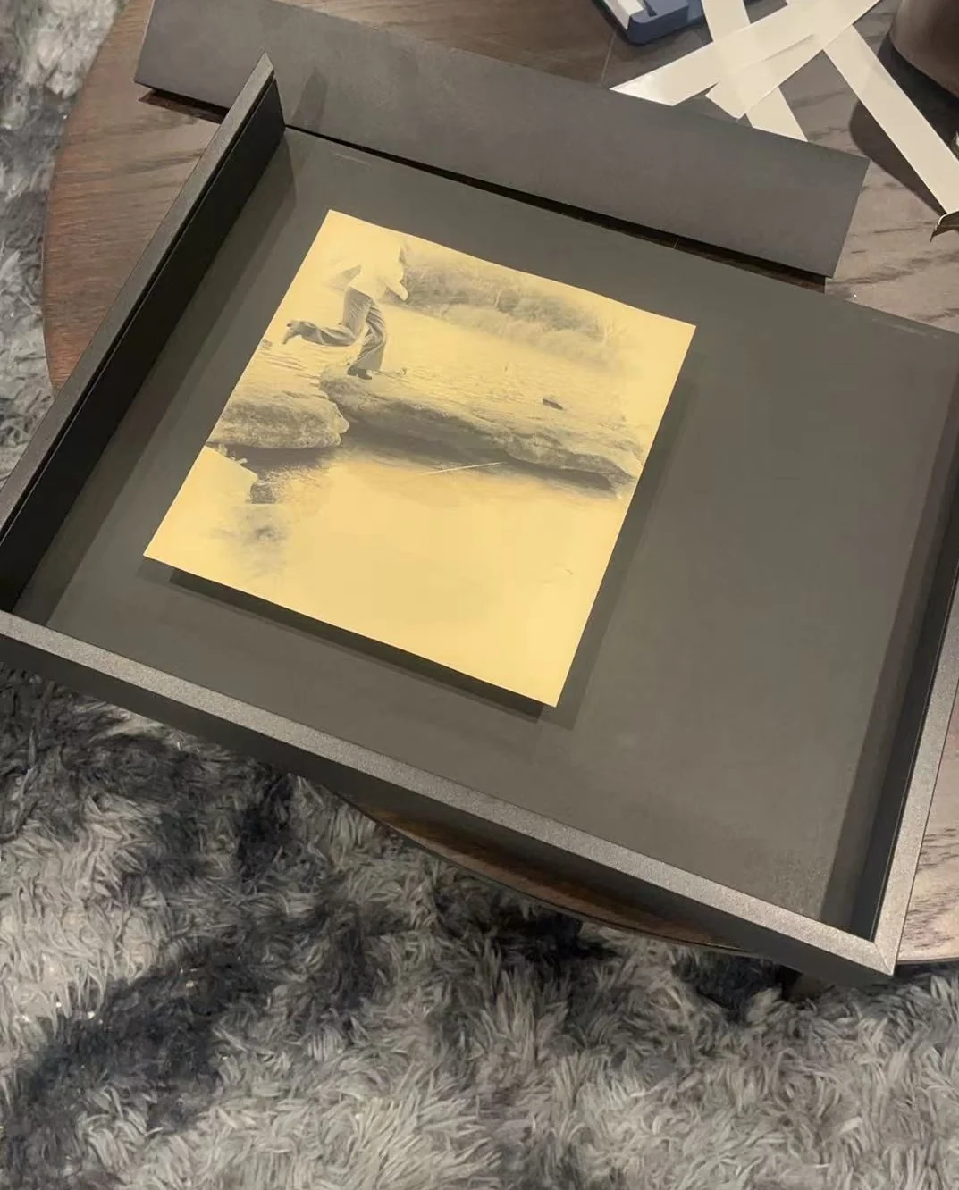 Framed platinum print study resting on a dark presentation surface.