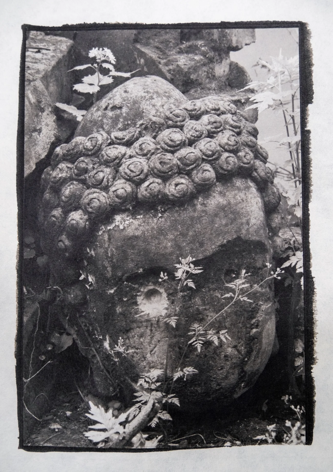 Vertical platinum print study showing a textured Buddha head image on handmade paper.