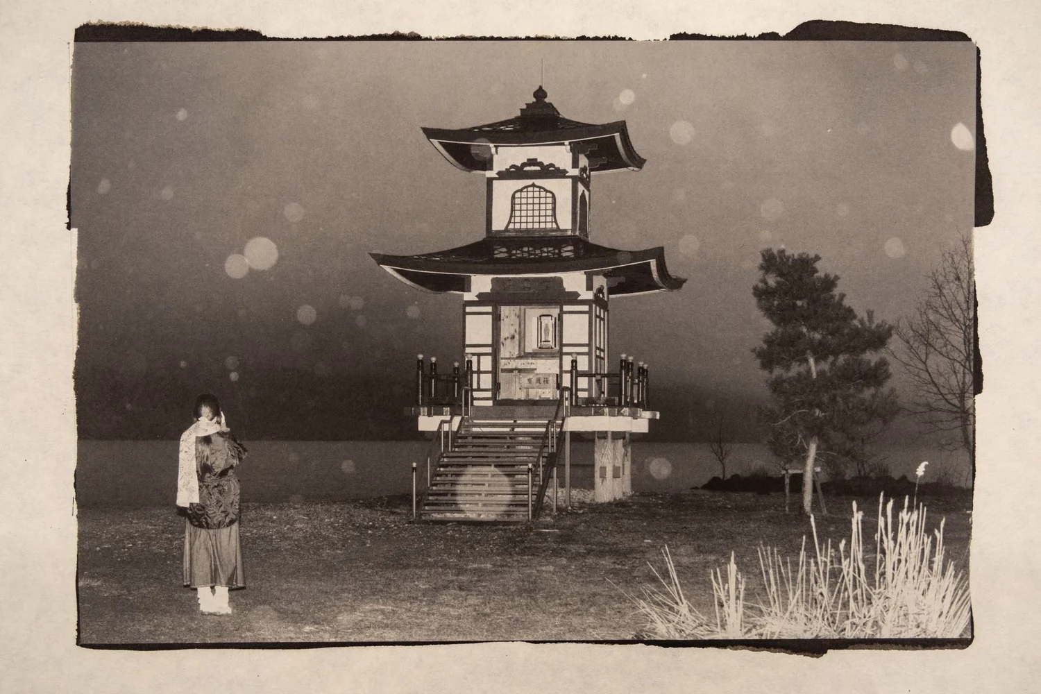 Platinum print study of a pagoda-like structure with a small figure in the foreground.