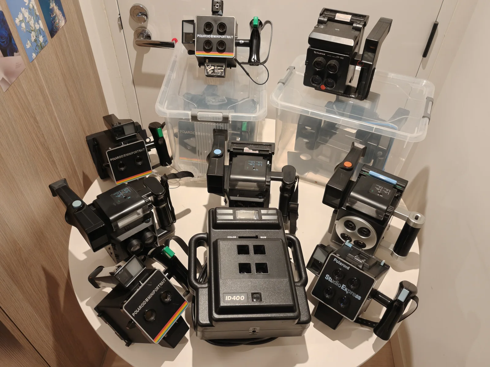 Multi-lens instant portrait camera systems arranged in a studio setting.