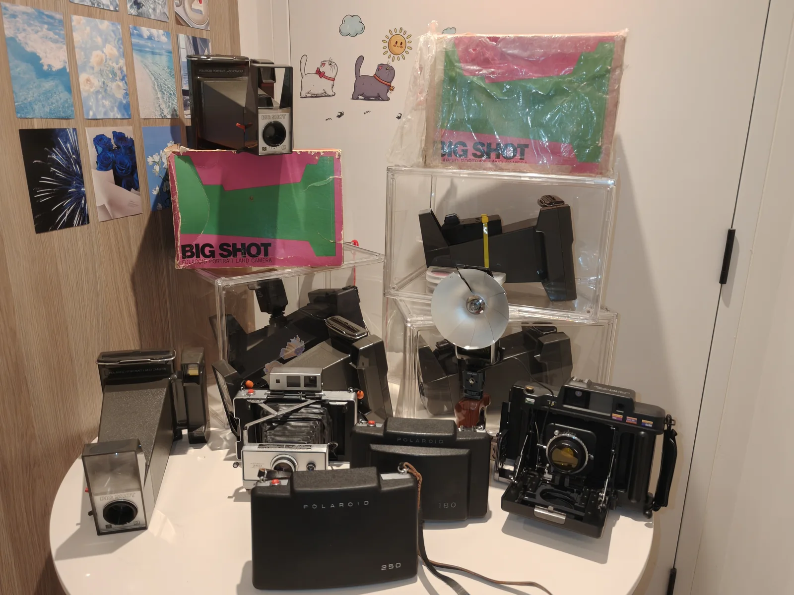 Studio table with Polaroid cameras, Big Shot materials and instant photography systems.