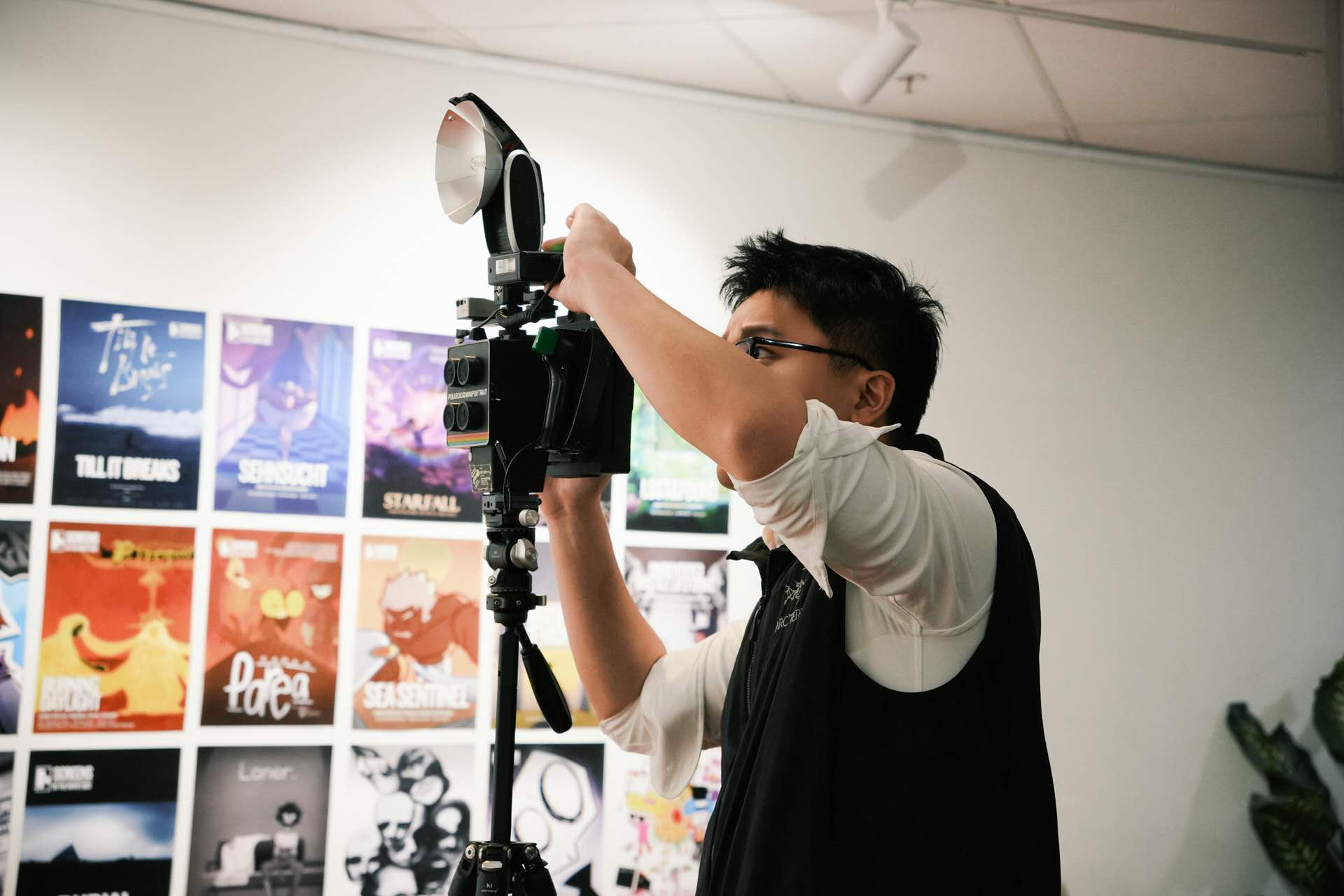 The artist working with a camera and flash.
